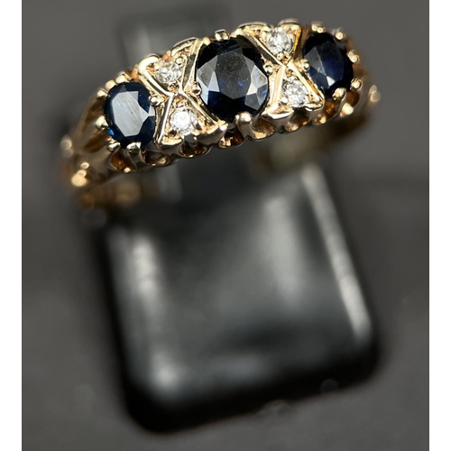 690 - A 9ct hallmarked gold gypsy style ring set with 3 sapphires, 2 diamond chips between each sapphire, ... 