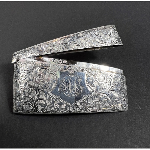 708 - A card case, Edwardian silver, of curved rectangular form with floreate chasing, Birmingham, 1909