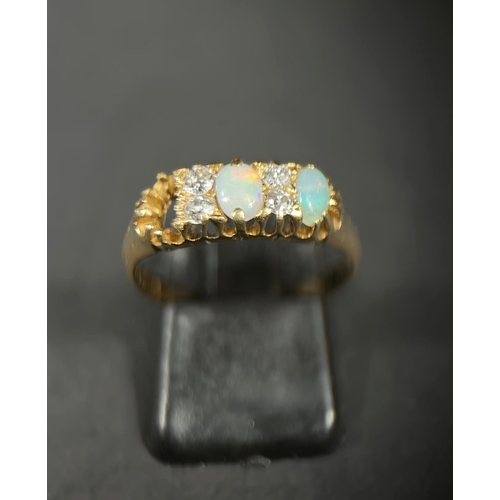 744 - An 18ct gold dress ring set with four diamonds and two opals (gap for a 3rd missing) 3.7gm M/N