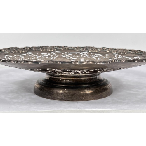 605 - A hallmarked silver shallow dish with relief and pierced vine decoration, on circular foot, Sheffiel... 