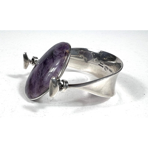 650 - Georg Jensen:designed by Vivianna Torun Bulow-Hube, a silver bangle with central oval polished ameth... 