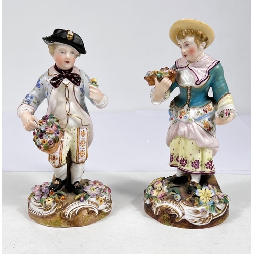 518 - A pair of 19th century Meissen style figures of children in 18th century dress gathering flowers wit... 