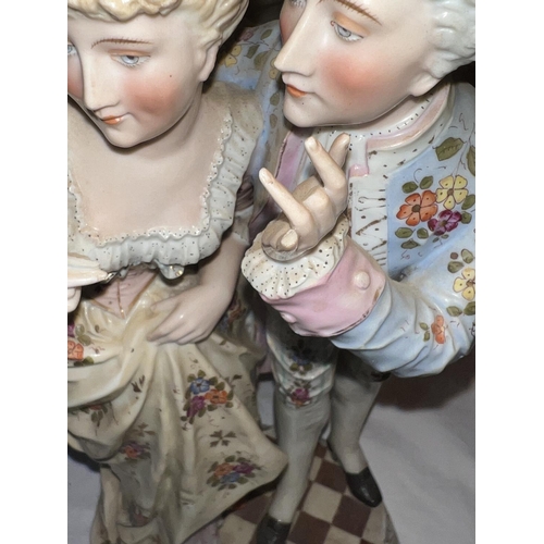 582 - A Meissen style porcelain group of period dressed lady and gentleman (gingers a/f) sword cross mark ... 