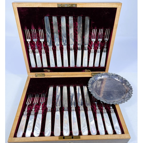 600 - A hallmarked silver set of 12 dessert knives and forks with mother-of-pearl handles, in walnut case,... 