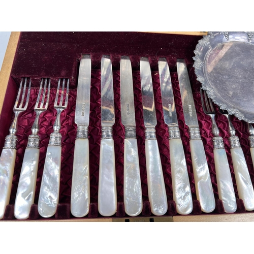 600 - A hallmarked silver set of 12 dessert knives and forks with mother-of-pearl handles, in walnut case,... 