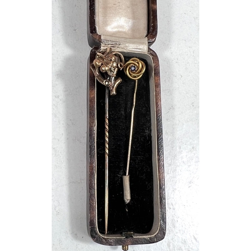 794 - Two yellow metal stick pins, one with stone, one with branch and leaf, both test approx. 14ct, 5.6gm