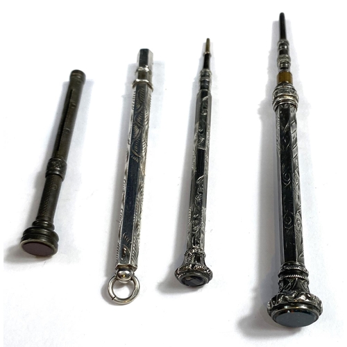 174 - Four miniature silver/white metal propelling pencils, three with seal tops