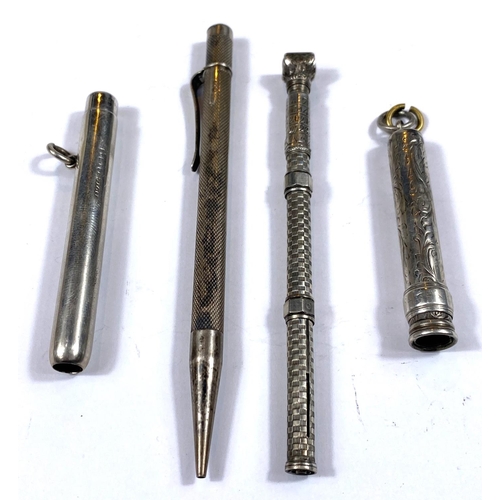 176 - A silver propelling pencil with seal top, calculator and other silver propelling pencils