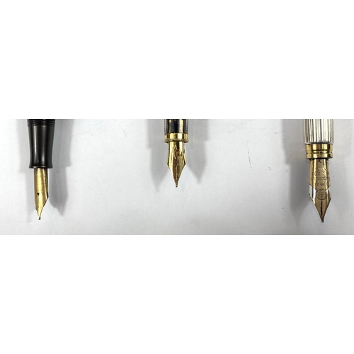 185 - A Watermans vintage fountain pen with 9ct gold bands, another Watermans and another