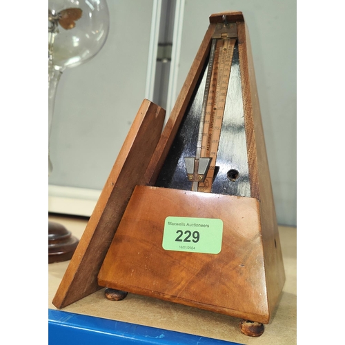 229 - A walnut cased metronome