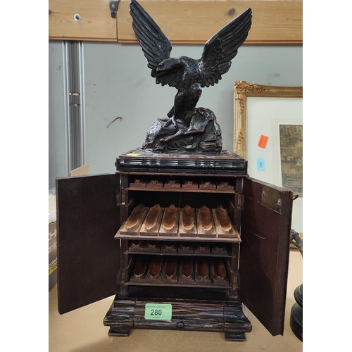 280 - A 19th Black Forest carved cigar humidor in the form of eagle standing atop cupboard with double doo... 