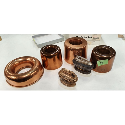 50 - A selection of copper jelly moulds, some named two plated table lighters 