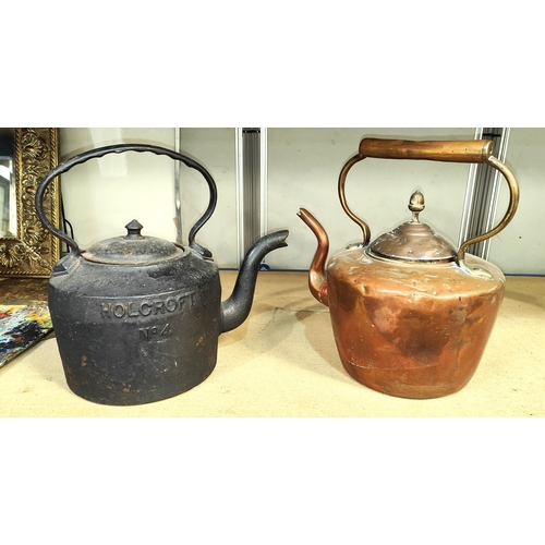 6 - A large cast iron kettle and a similar copper kettle