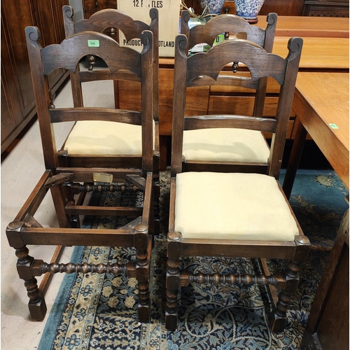 898 - A set of four oak dining chairs, turned stretcher and shaped backs