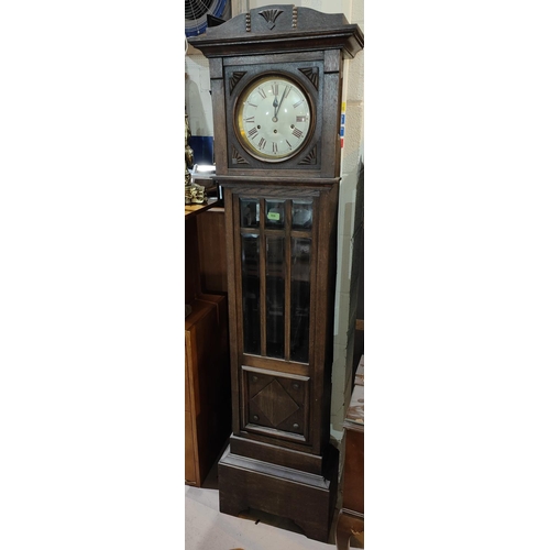 906 - A 1930's oak hall clock with bevelled glass panels to front with circular gilded and brass dial, pen... 