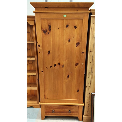 915 - A modern pine wardrobe with single drawer and door, ht. 187 x 87cm