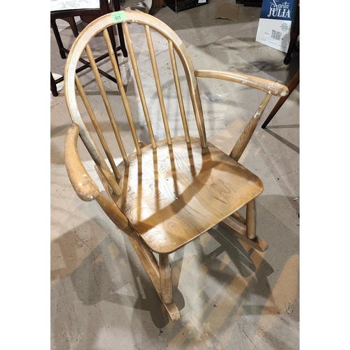 925 - An Ercol light wood stick back rocking chair; a pine chair and stool