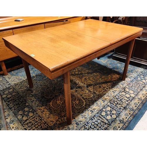 927 - A mid 20th century White & Newton rectangular extending teak table with build in fold out leaf, ... 