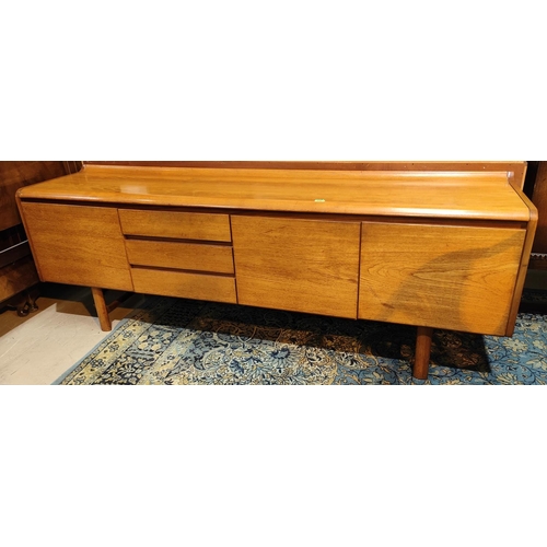 928 - A mid 20th century White & Newton teak long low sideboard with single and double door cupboard a... 