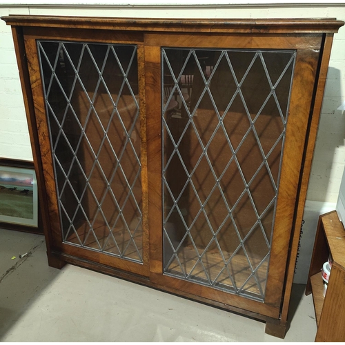 929 - A walnut leaded astragal glaze sliding door display cabinet, ht. 124 x length 125cm