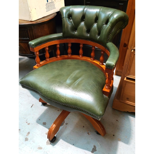 930 - A traditional style office desk chair with antique green leather button back and seat, swivel with l... 