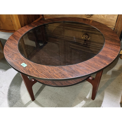 932 - A 1960's simulated rosewood occasional table with circular glass top