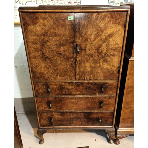 942 - A 1930's figured walnut tallboy with double cupboard over 3 drawers