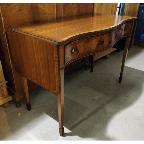 947 - A Regency style mahogany side table with crossbanded decoration, serpentine front, 2 drawers and dro... 