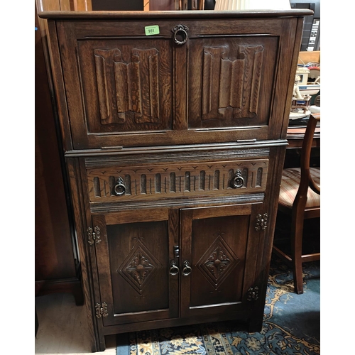 951 - A Jacobean style oak drinks cabinet with fall front cocktail section, drawer and double cupboard und... 