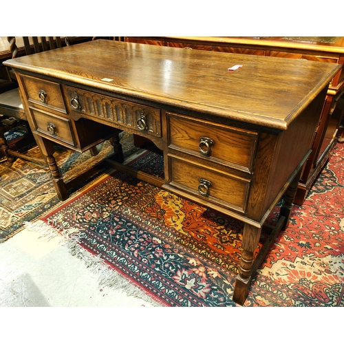 954 - A period style oak kneehole desk of 5 drawers and an Ercol stickback chair 