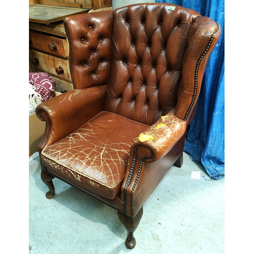 991 - A brown leather deep buttoned armchair (a/f)