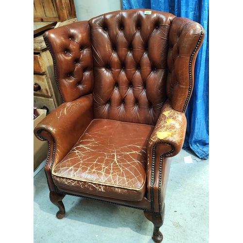 991 - A brown leather deep buttoned armchair (a/f)