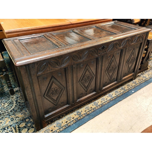 994 - An 18th century framed and panelled oak bedding box with hinged lid and block feet, width 145cm