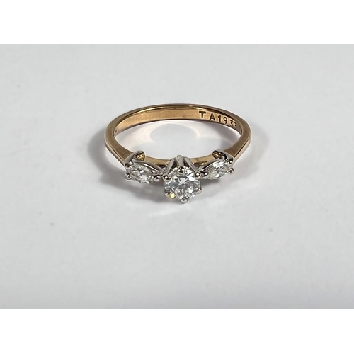 705 - A diamond dress ring set single brilliant cut flanked by marquise cut stones, 18ct shank