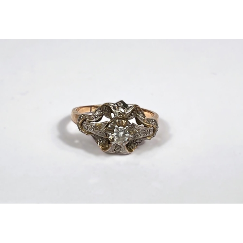 794D - A diamond set dress ring in cross shaped setting, unmarked tests as 18ct approx.