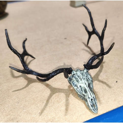 165 - A miniature bronze sculpture of a deer skull and antlers, signed to base F Boyer, width 12cm