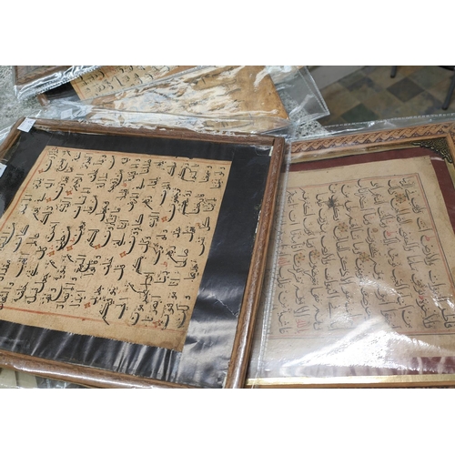 195A - A collection of Middle Eastern text pages framed, the text with coloured and gilt highlights