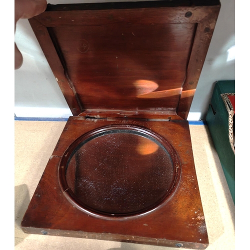 234 - A circular concave mirror in mahogany case, possibly a ship's signalling mirror