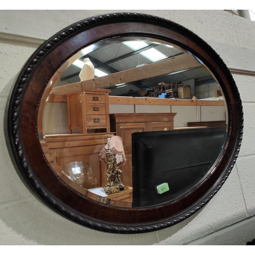 871 - A Victorian oval footstool; a wall mirror in oval mahogany frame