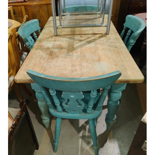 907 - A pine kitchen table with painted legs and stripped top, 140 x 75cm and four pine lathe back chairs ... 