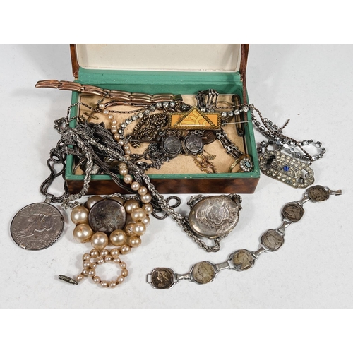 671 - A small box of costume jewellery including 1972 American dollar pendant, pendant locket etc