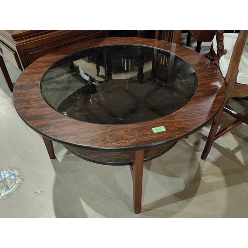 932 - A 1960's simulated rosewood occasional table with circular glass top