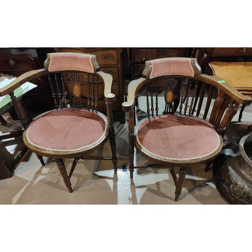 944 - An Edwardian pair of tub shaped armchairs in inlaid mahogany