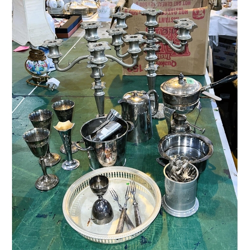 658 - A silver plated brandy warmer on burner base; a pair of 5-branch candelabra; other silver plate