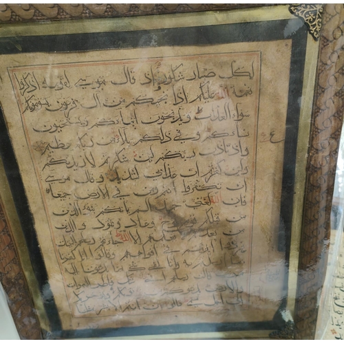 195A - A collection of Middle Eastern text pages framed, the text with coloured and gilt highlights