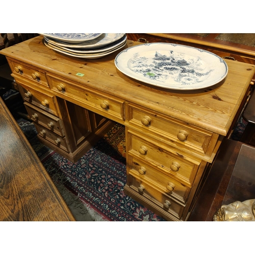 889 - A pine kneehole desk with  drawers