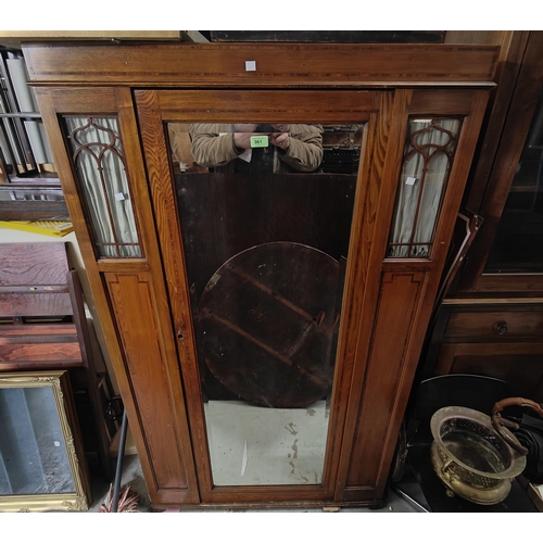 961 - An Edwardian small wardrobe with mirror door and glazed panels