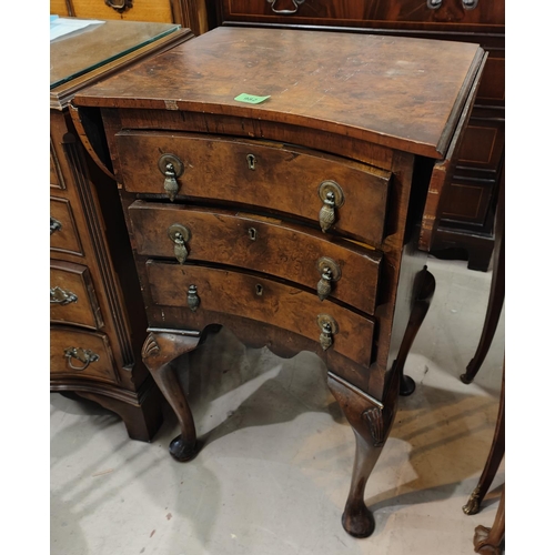 982 - A walnut concave front chest of three drawers with rounded fall flaps, shell designs on cabriole leg... 