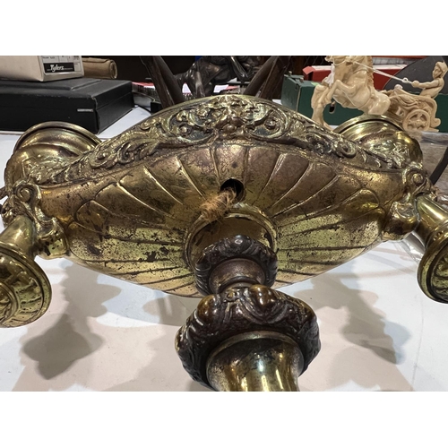 98 - A period style brass oil lamp with double light (converted); a brass vase; a wall light