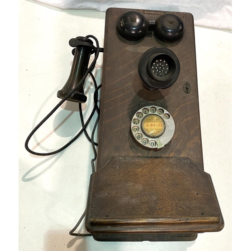 104 - An early 20th century Western Electric made in the USA, oak cased wall telephone with bakelite fitti... 